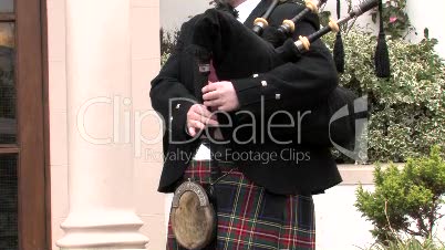 Traditionally Dressed Scotsman Plays The Bagpipes