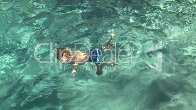Young Girl and Boy Swimming Underwater