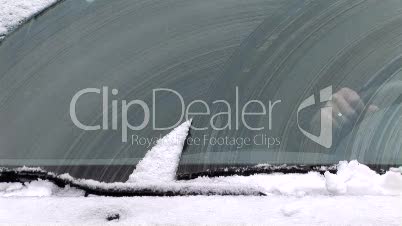 Windshield wipers clearing off the snow