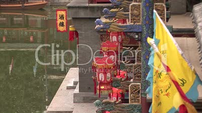 Colorful flags, lanterns and gargoyles by the water