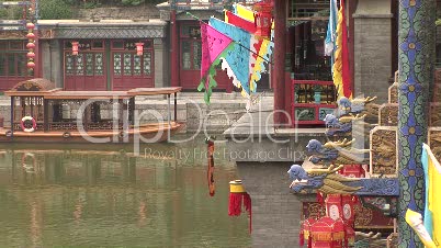 Colorful flags, lanterns, gargoyles and ferry boat on the water