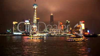 Brightly lit ships cruising Shanghai, time lapse