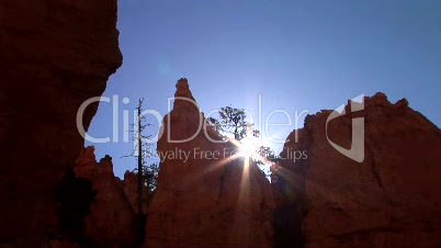 Sun breaks over rock, time lapse