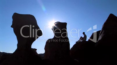 Man on rock in silhouette