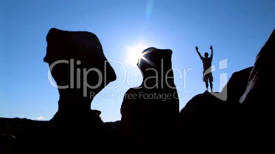 Man on rock in silhouette