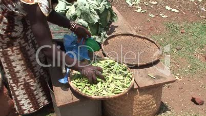Malawi: african woman sells pease in a market