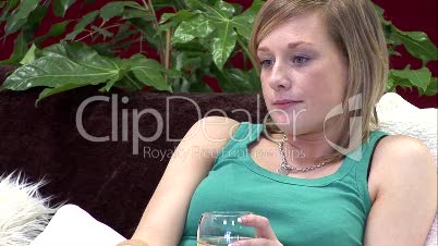 Woman on Sofa relaxing with a Glass of Wine