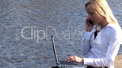 Woman on laptop outdoors