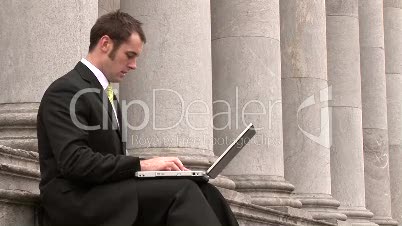 Business man Outdoors Using Laptop