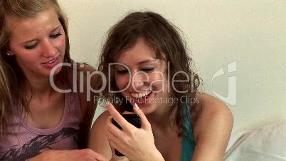 Two Girls in Bedroom with an Iphone