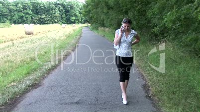 HD1080i Woman talking on the phone outdoors in nature.