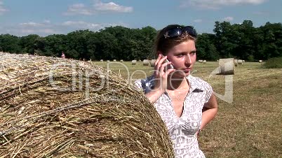 HD1080i Young woman talking on the phone outdoors in nature.