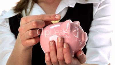 Woman Saving Money in a Piggy Bank
