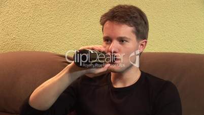 HD1080i Young man drinking a beer and watching tv