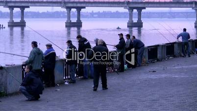 Group of fishermen on quay of Dnepr. Ukraine. Dnepropetrovsk.