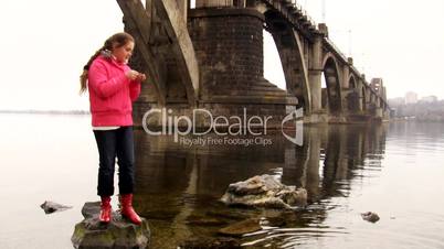 Girl throwing pebble in the water