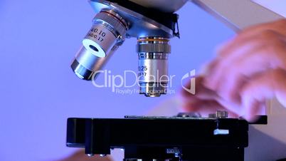Nahaufnahme - Frauenhand an Mikroskop