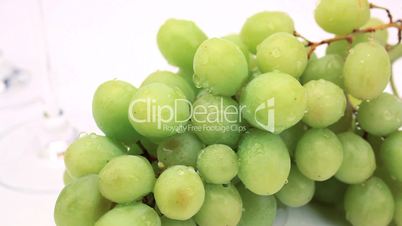 Grüne Trauben neben Weingläsern