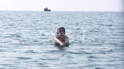 girl dives into the sea.