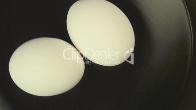 Whole eggs on a black plate
