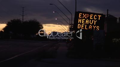 Warning sign and traffic at dusk