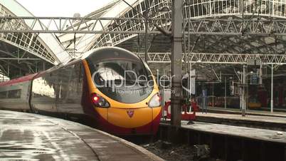 Virgin Pendolino train coming out of a tunnel into station