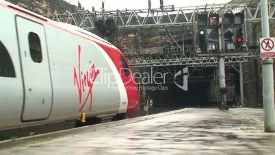 Virgin Pendolino train coming out of a tunnel into station