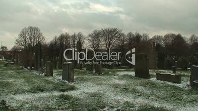 Man fades away walking in a cemetery