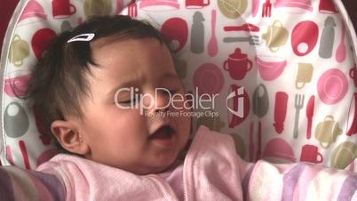 Baby girl sitting in high chair 4