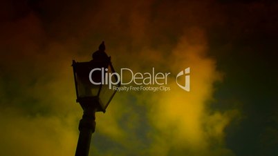 Time lapse clouds flow past a victorian lamppost