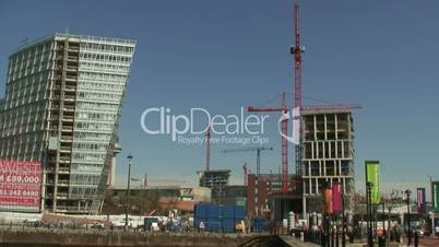 (Time-lapse) 6 huge tower cranes turning with people and cars