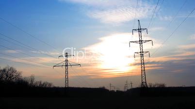 sunset with electricity pylon. time lapse.