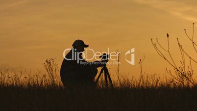 Silhouette of photographer against sunset.