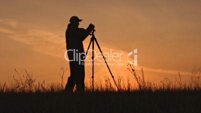 Silhouette of photographer against sunset.
