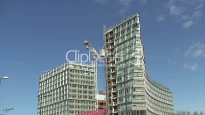 Time-lapse construction workers lift building apartment blocks.