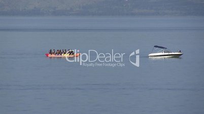 A banana boat with tourists speeds away