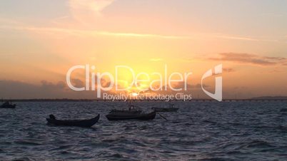 Small fishing boats at sunset
