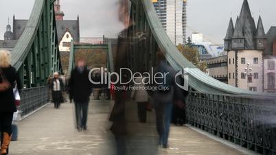 People walking over a bridge. Time lapse.