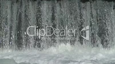 Curtain of water falling over a dam