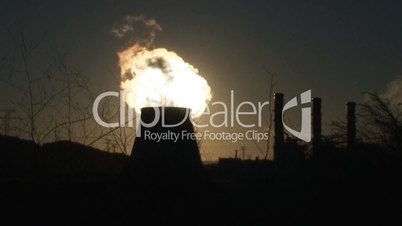 Chimney of power plant against sun