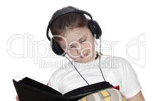 girl listens to music and looks book.