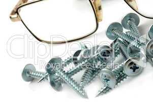Still-life of glasses with screws.