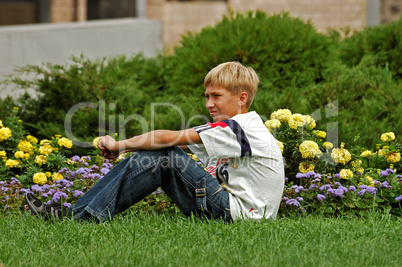 teenager sits on a grass teenager sits on a grass