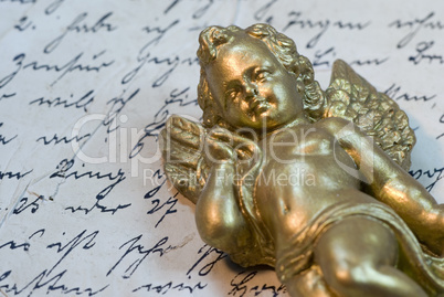 little angel statue on old letter