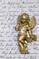 little angel statue on old letter