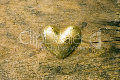 gold heart on wood