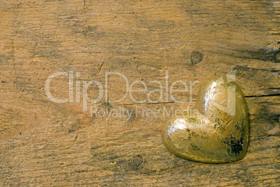 gold heart on wood