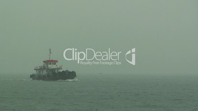Tug boat sailing in storm