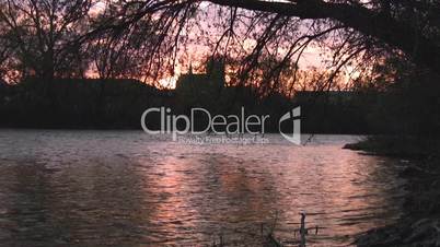 Sunset reflection over river with background church