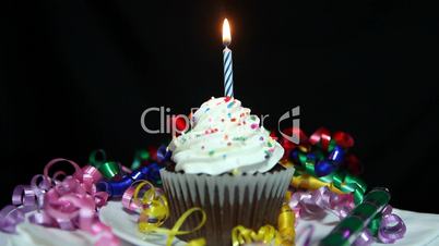 Happy Birthday Cupcake With Candles Being Lit and Burning Out.